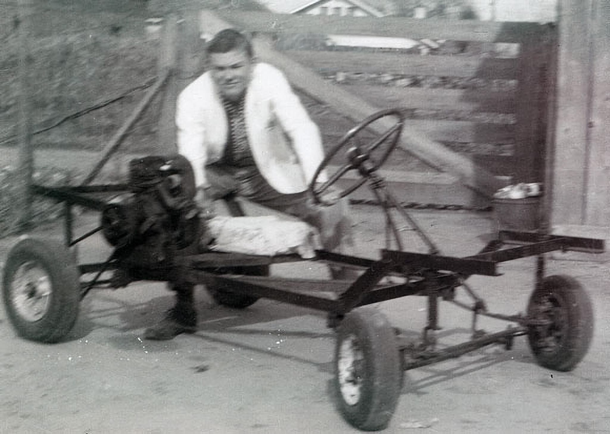 EJ Hurdle with his home built car in the back yard